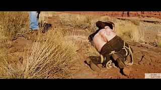 Gigantic-behind blonde gets her ass-hole whipped, then gets rough anal sex in dirt and piss -- a real BDSM session outdoors in the Western USA with Rebel Rhyder