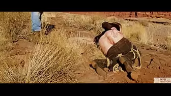 Gigantic-behind blonde gets her ass-hole whipped, then gets rough anal sex in dirt and piss -- a real BDSM session outdoors in the Western USA with Rebel Rhyder